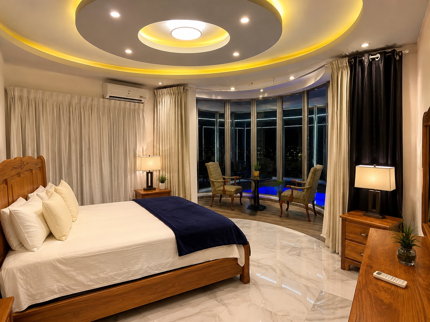 Spacious suite with curved windows and warm evening lighting