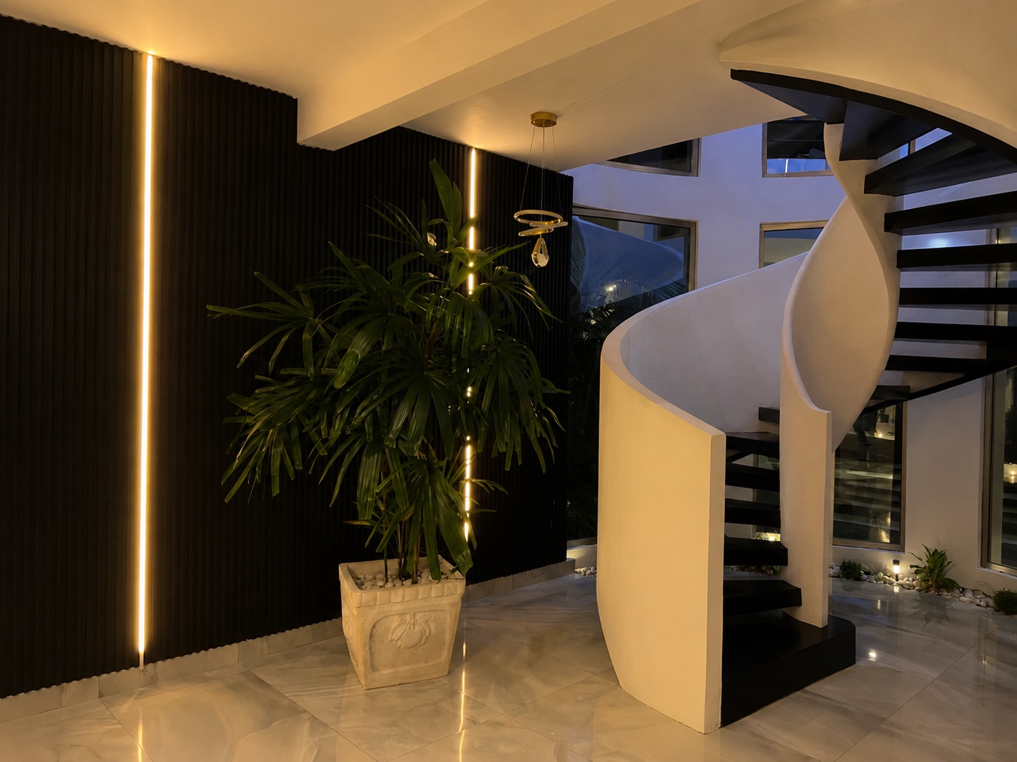 Sculptural staircase and illuminated interior garden